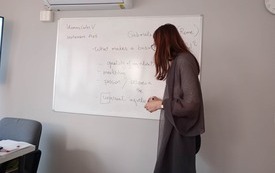 Nauczycielka zapisuje słowa w języku angielskim na tablicy