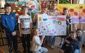 Uczniowie trzymają plakat