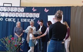 Komisja wręcza dyplom dziewczynce